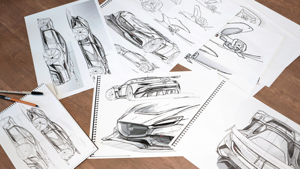 Sheets of paper with pencil sketches of cars